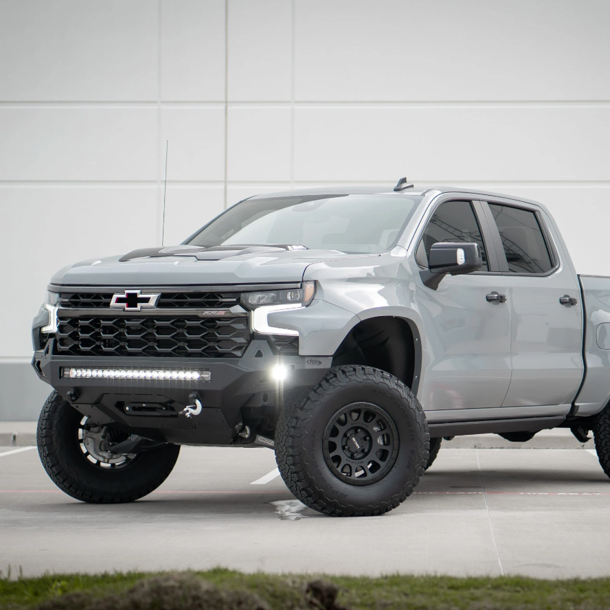 2019-2025 Chevrolet Silverado fenders displayed on a lifted gray truck with offroad tires and a rugged front bumper.