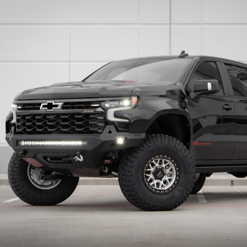 2019-2025 Chevrolet Silverado fenders showcased on a modified black truck with off-road tires and LED lights.
