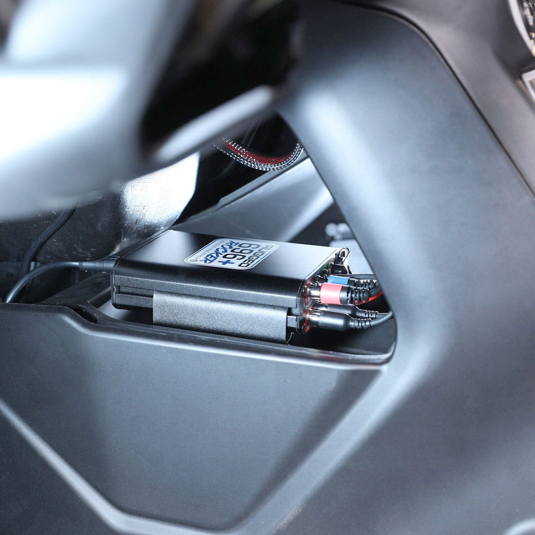 Can-Am Maverick R remote head top mount kit installed in a vehicle, showcasing its compact design and wiring connections.