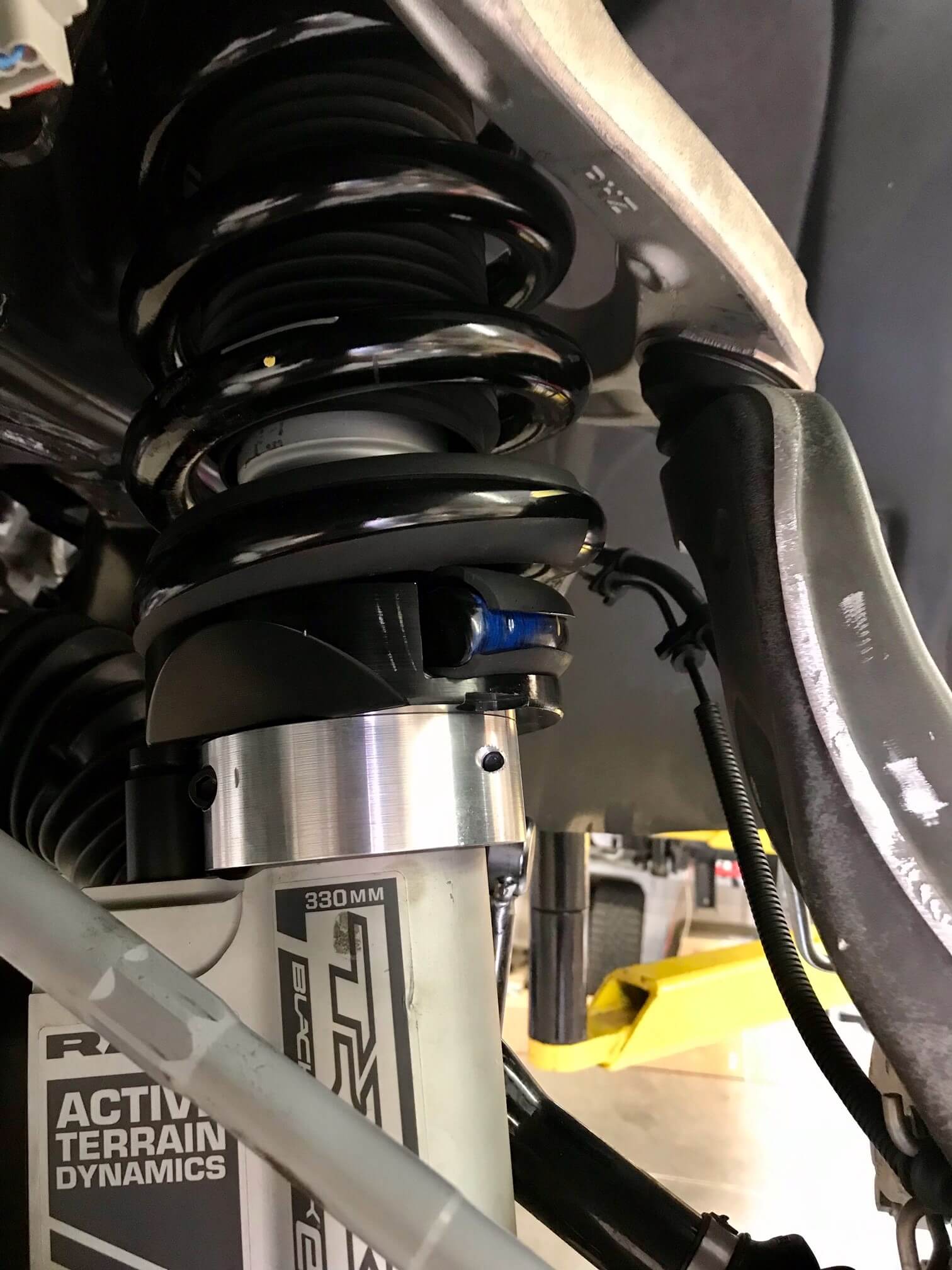 2025 Ram RHO 1.5 inch front leveling kit showcasing the suspension components and shock absorber installation.