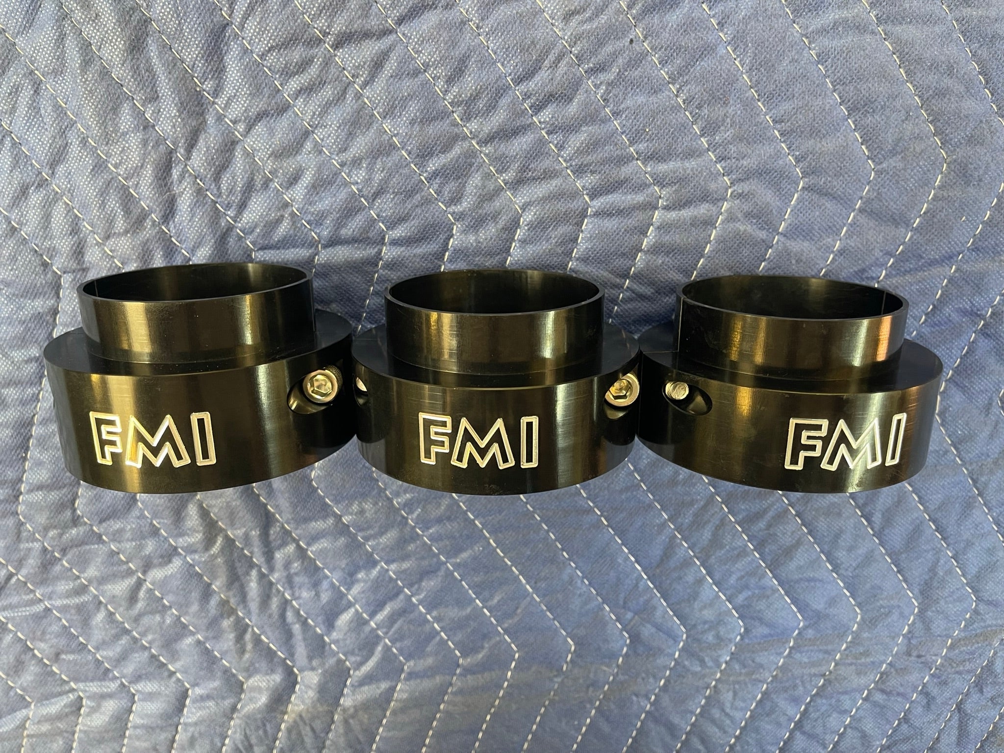 2021-2024 Ram TRX 2-inch front leveling kit featuring three black aluminum spacers with FMI branding.