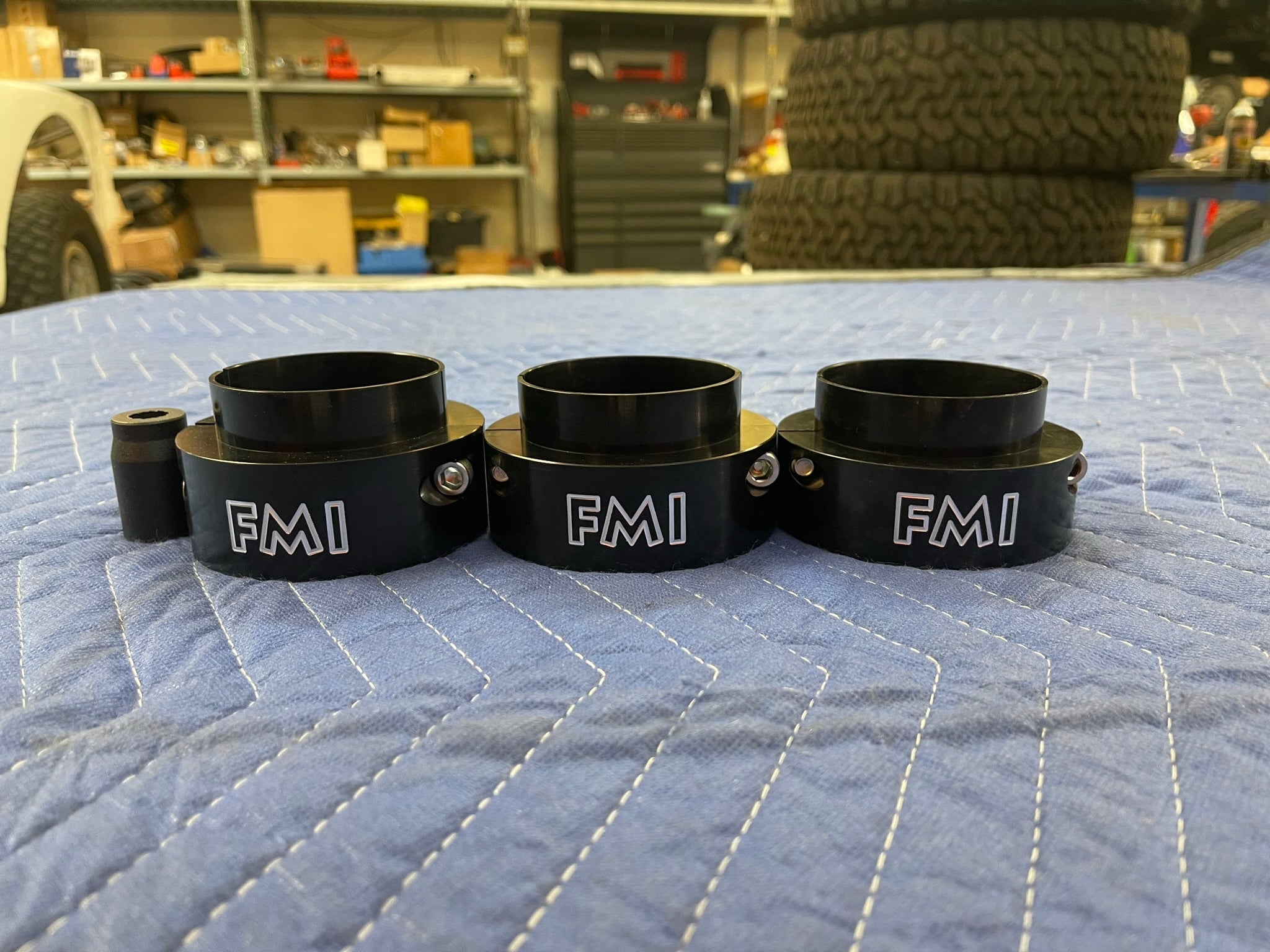 2021-2024 Ram TRX 2-inch front leveling kit components displayed on a blue protective cover in a workshop setting.