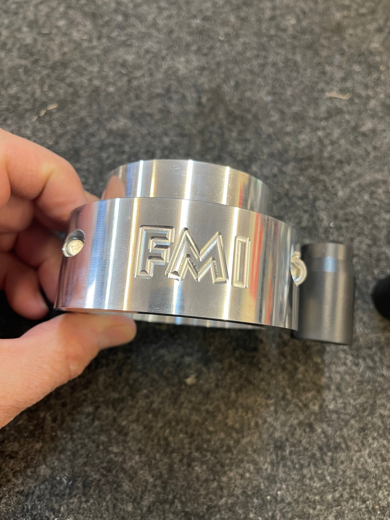 2021-2024 Ram TRX 1.5-inch front leveling kit component showcasing polished metal design and branding.