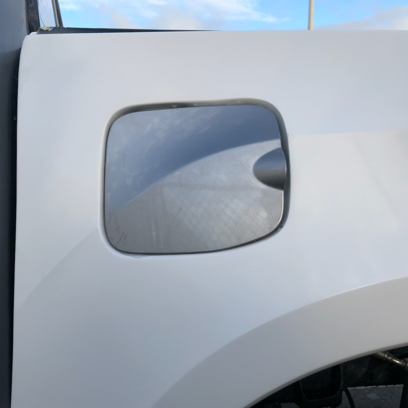 2016-2023 Toyota Tacoma bedsides showcasing a smooth, unpainted surface with a cutout for the fuel filler.