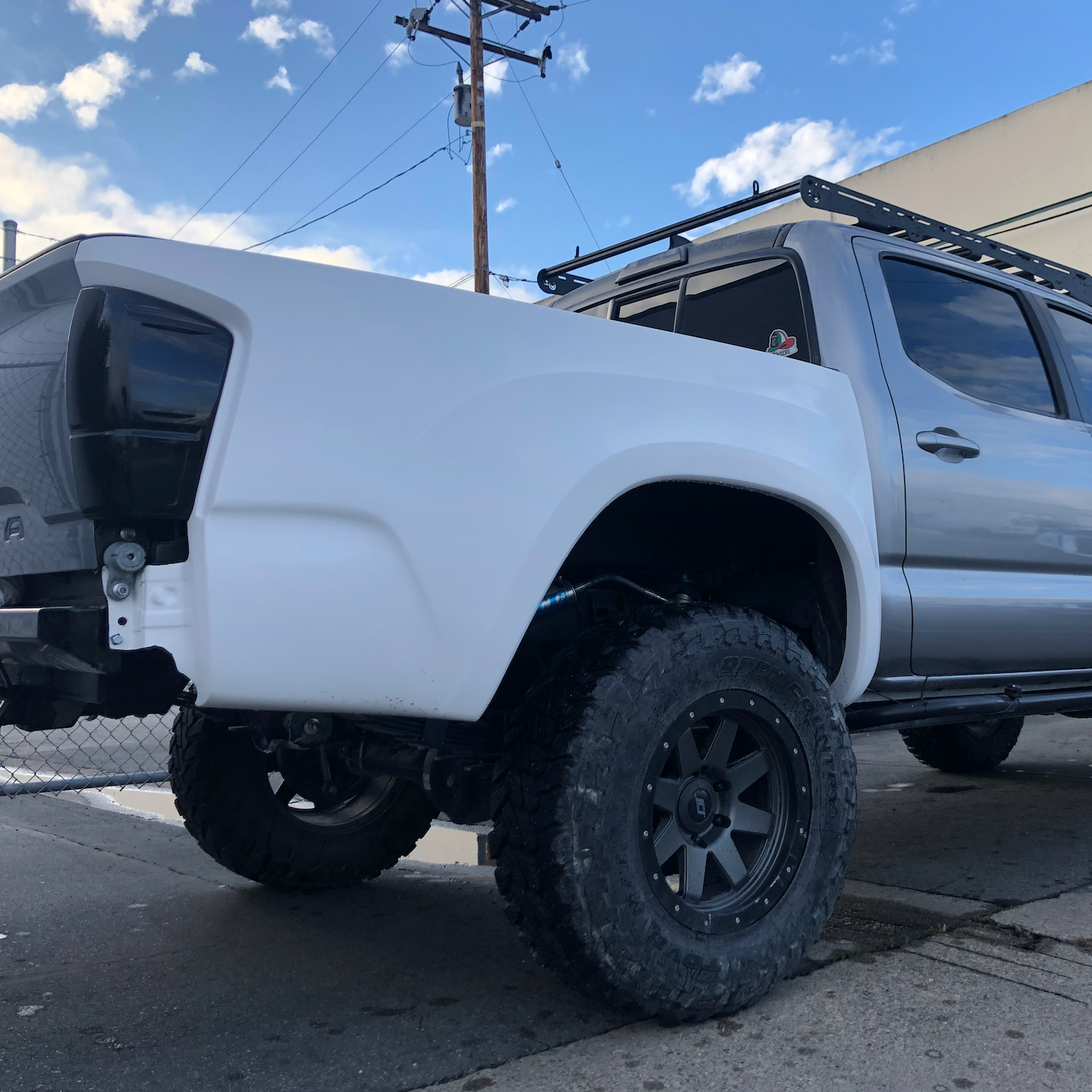 2016-2023 Toyota Tacoma with custom bedsides and offroad tires, showcasing a rugged and elevated stance.