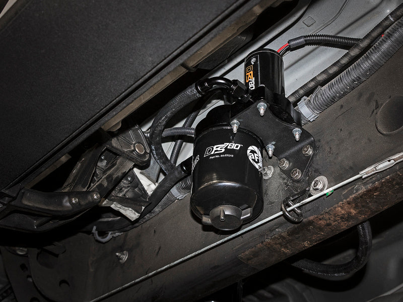 AFE DFS780 lift pump installed under a Ford diesel truck, designed for 2008-2010 V8-6.4L models, showcasing its robust design.