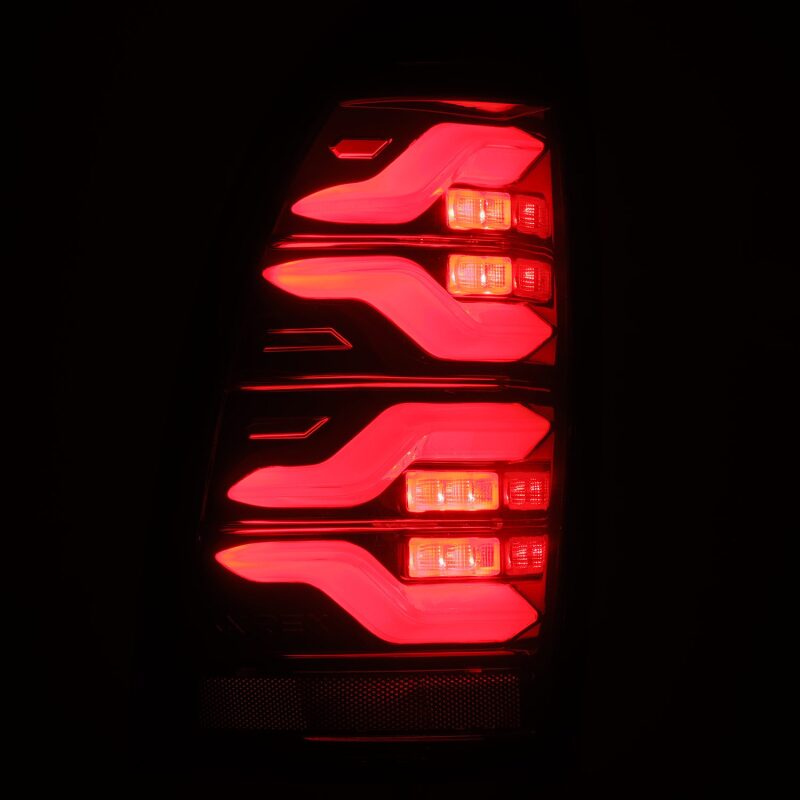AlphaRex LUXX LED taillights for 05-15 Toyota Tacoma in black and red with sequential signal and active light features.