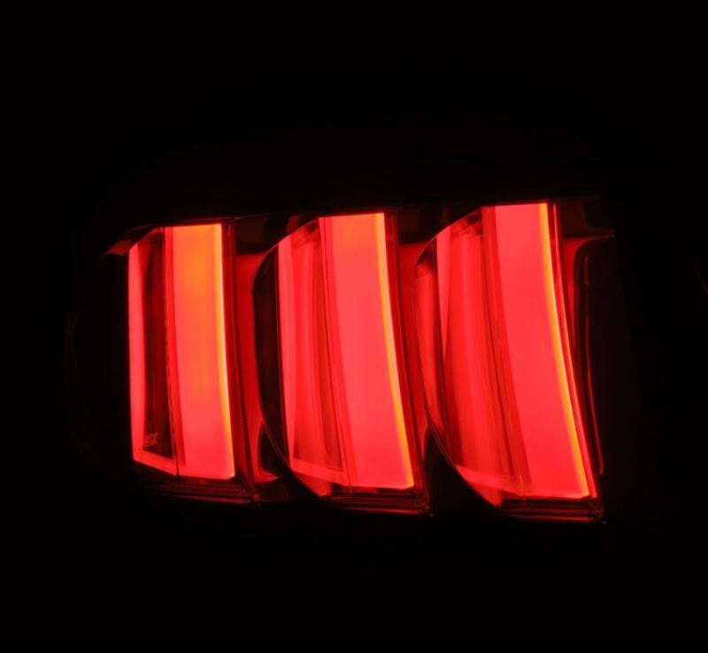 AlphaRex NOVA-Series prismatic LED tail lights for 2015-2023 Ford Mustang in black-clear finish, showcasing bright red illumination.
