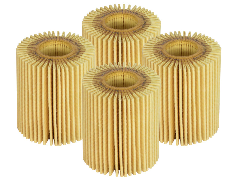 A set of four afe PROGUARD oil filters with a cylindrical design and pleated paper texture, ideal for vehicle maintenance.
