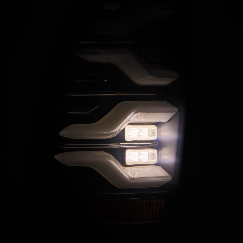 AlphaRex LUXX LED taillights for 05-15 Toyota Tacoma featuring black housing, sequential signals, and active lighting.