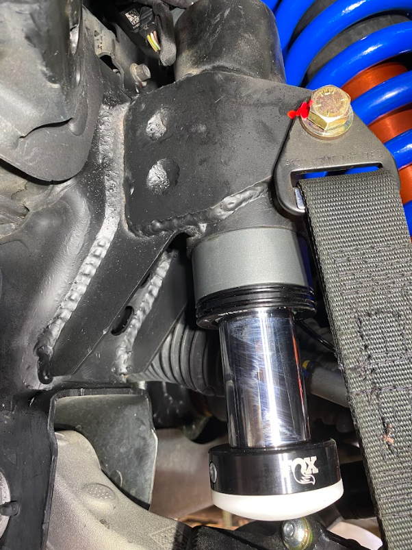 Front limit strap and bump stop for 2022+ Bronco Raptor, installed on stock lower arm for enhanced off-road performance.