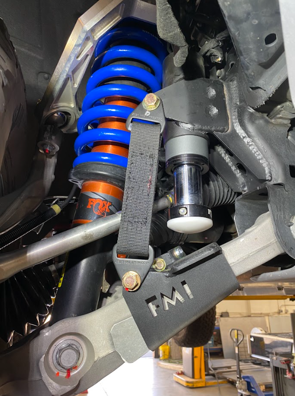 Front limit strap and bump stop for 2022+ Bronco Raptor, showcasing suspension components and stock lower arm.
