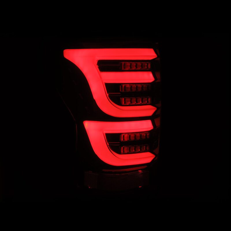 AlphaRex LUXX-Series LED tail lights for 07-13 Toyota Tundra in Alpha-Black, featuring a sleek, modern design with bright red illumination.