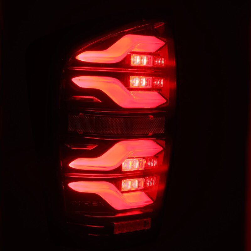 AlphaRex LUXX LED taillights for 2016-2021 Toyota Tacoma in black and red with sequential signal lights.
