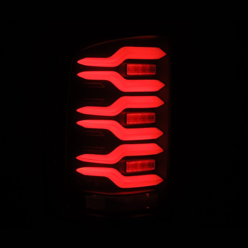 AlphaRex LUXX-Series LED tail lights for 14-18 GMC Sierra with black housing, featuring active lighting and sequential signals.