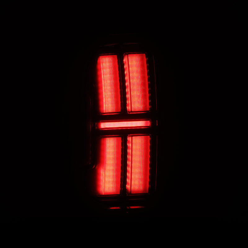 AlphaRex NOVA LED tail lights for 05-15 Toyota Tacoma in black, showcasing a sleek, modern design with bright red illumination.