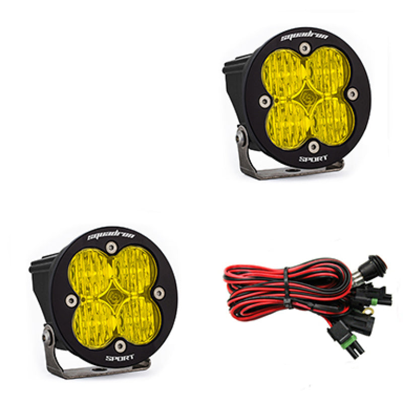 Baja Designs Squadron R Sport Wide Cornering Pair LED light pods in amber with mounting brackets and wiring harness.