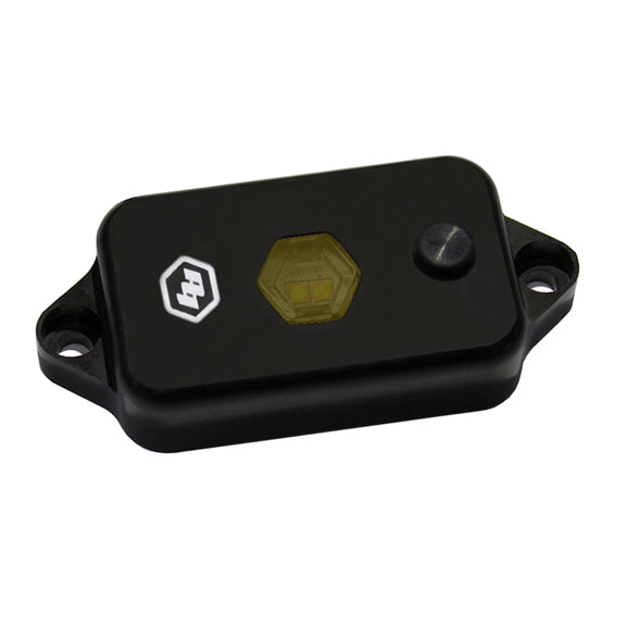 Baja Designs LED dome light with switch in amber color, featuring a sleek black housing and hexagonal lens.