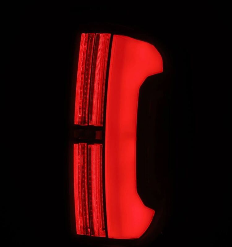 AlphaRex LED tail lights for 14-21 Toyota Tundra in black, featuring a sleek design and bright red illumination.