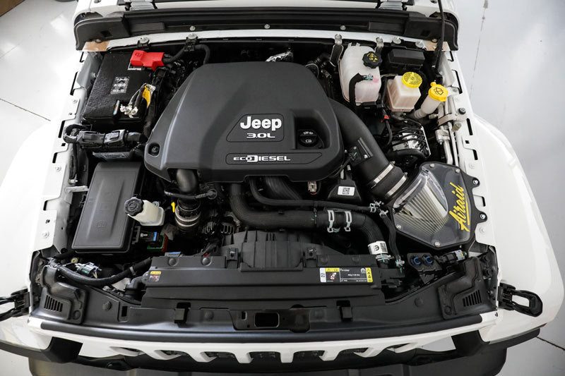 Airaid performance air intake system installed in a 2020-2021 Jeep Wrangler V6 3.0L diesel engine compartment.