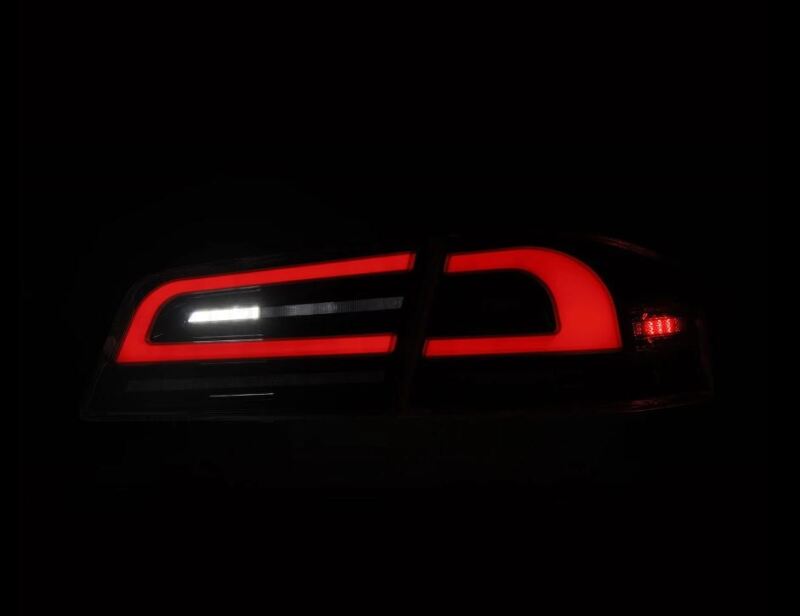 AlphaRex LUXX-Series LED tail lights for 12-21 Tesla Model S in black, featuring a sleek design with vibrant red illumination.