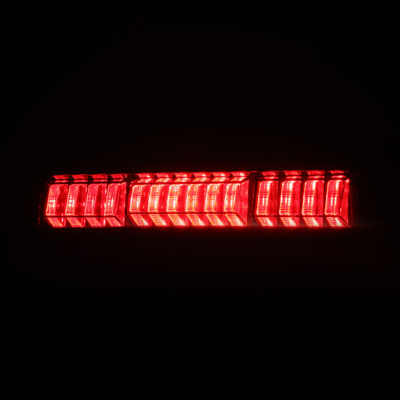 AlphaRex LUXX-Series LED 3rd brake light for 2016-2023 Toyota Tacoma in black smoke finish, showcasing bright red illumination.