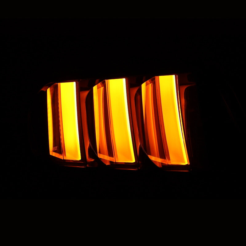 AlphaRex NOVA-Series prismatic LED tail lights for 2015-2023 Ford Mustang in alpha-black finish, glowing amber.