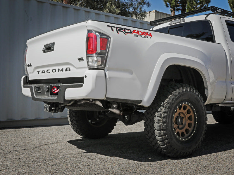 A white Toyota Tacoma with aaf MACH Force-Xp tailpipe installed, showcasing an upgraded exhaust system and rugged tires.