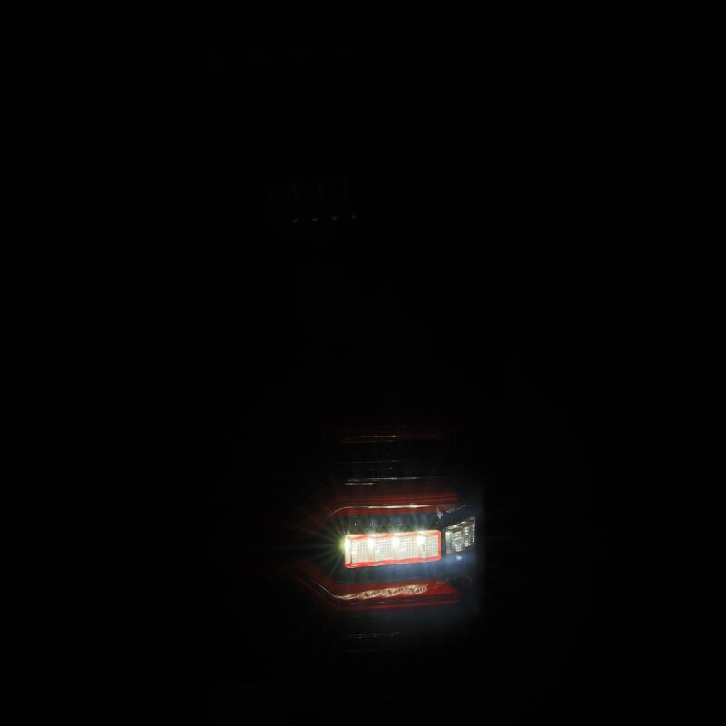 AlphaRex Luxx-Series LED tail lights for 19-21 Dodge Ram 1500 in black and red with sequential signals and active lighting.