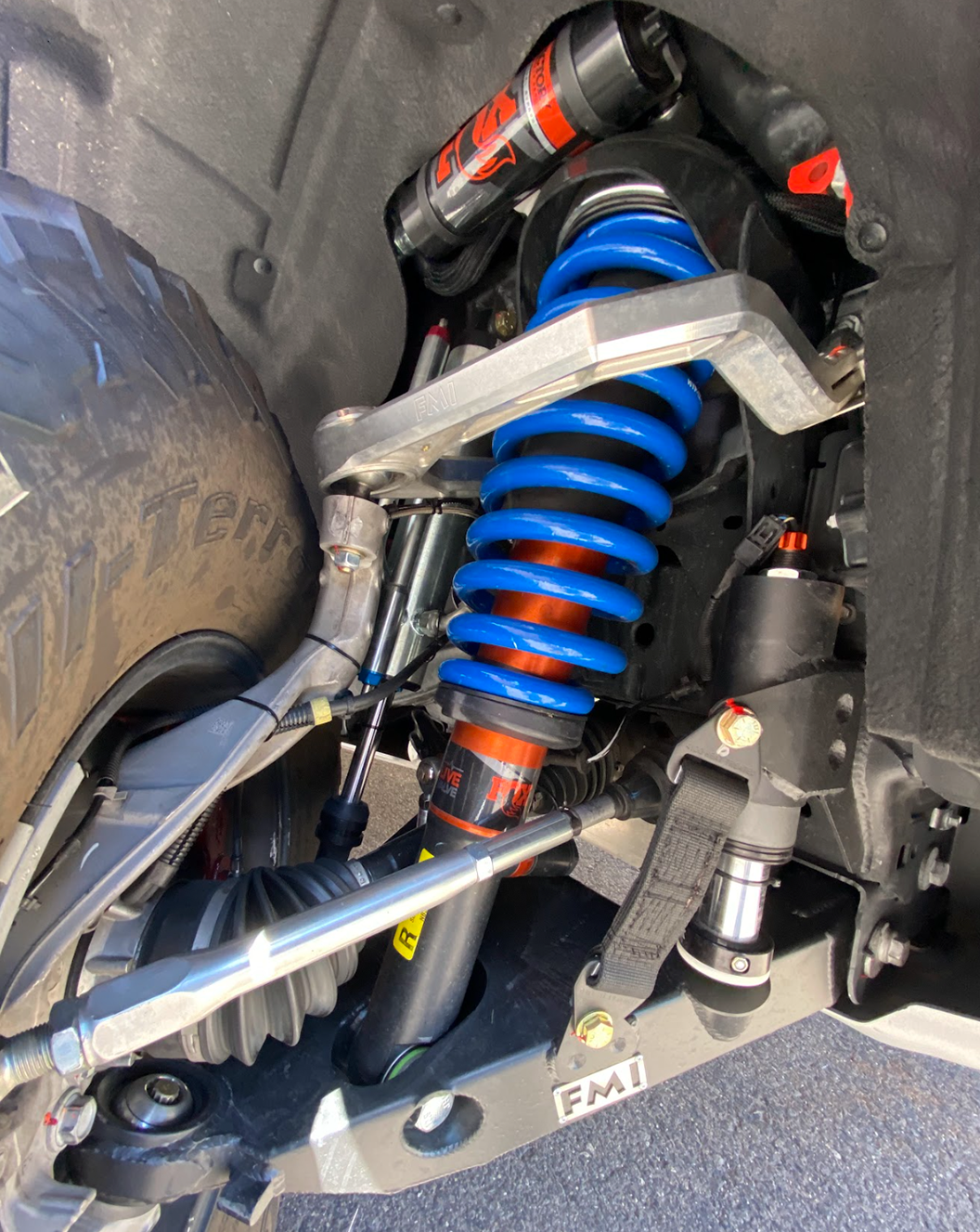 2022 Bronco Raptor mid travel front suspension kit showcasing blue coil springs and shock absorbers for enhanced offroad performance.