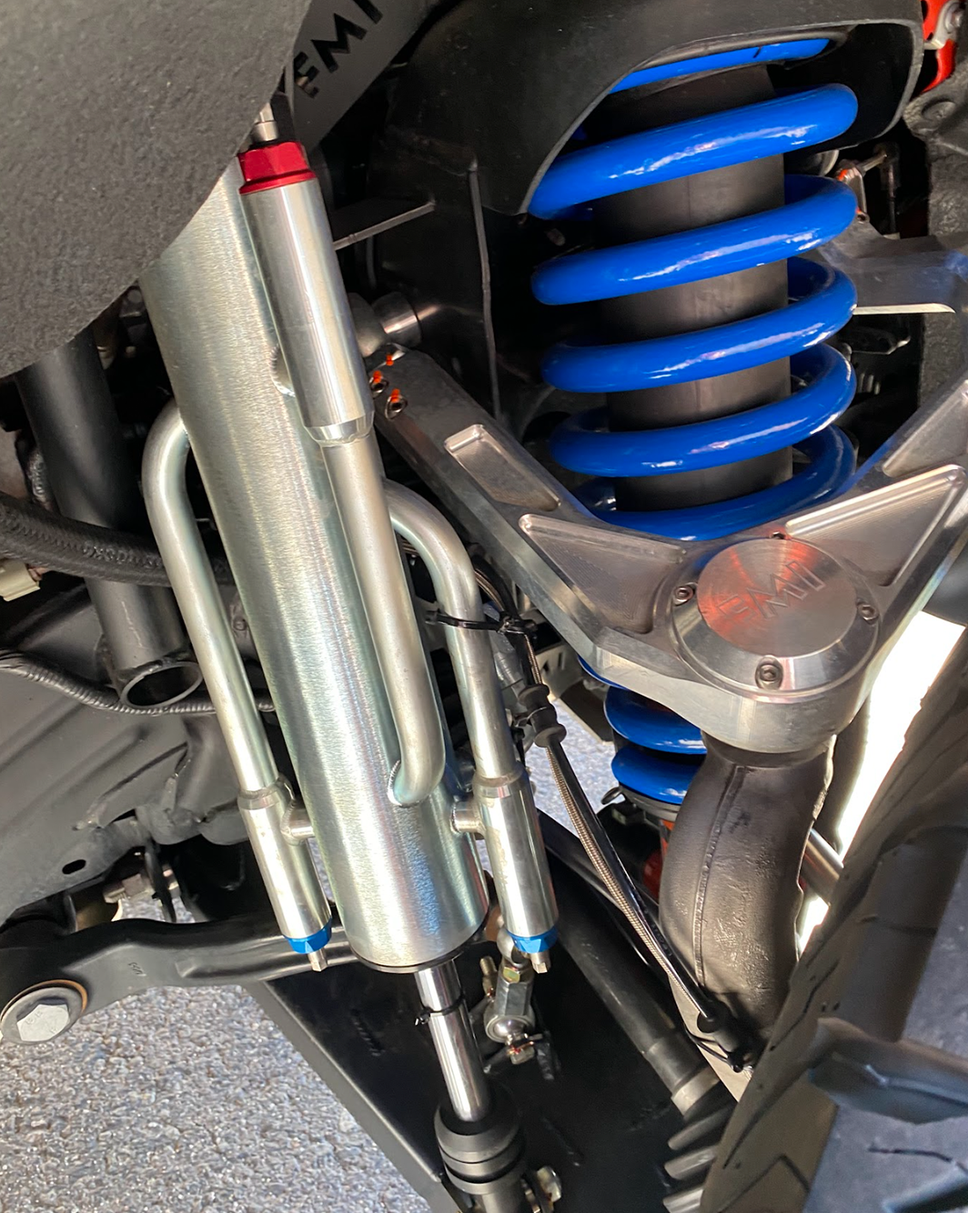 2022+ Bronco Raptor mid travel front suspension kit showcasing blue coil springs and aluminum components for enhanced off-road performance.