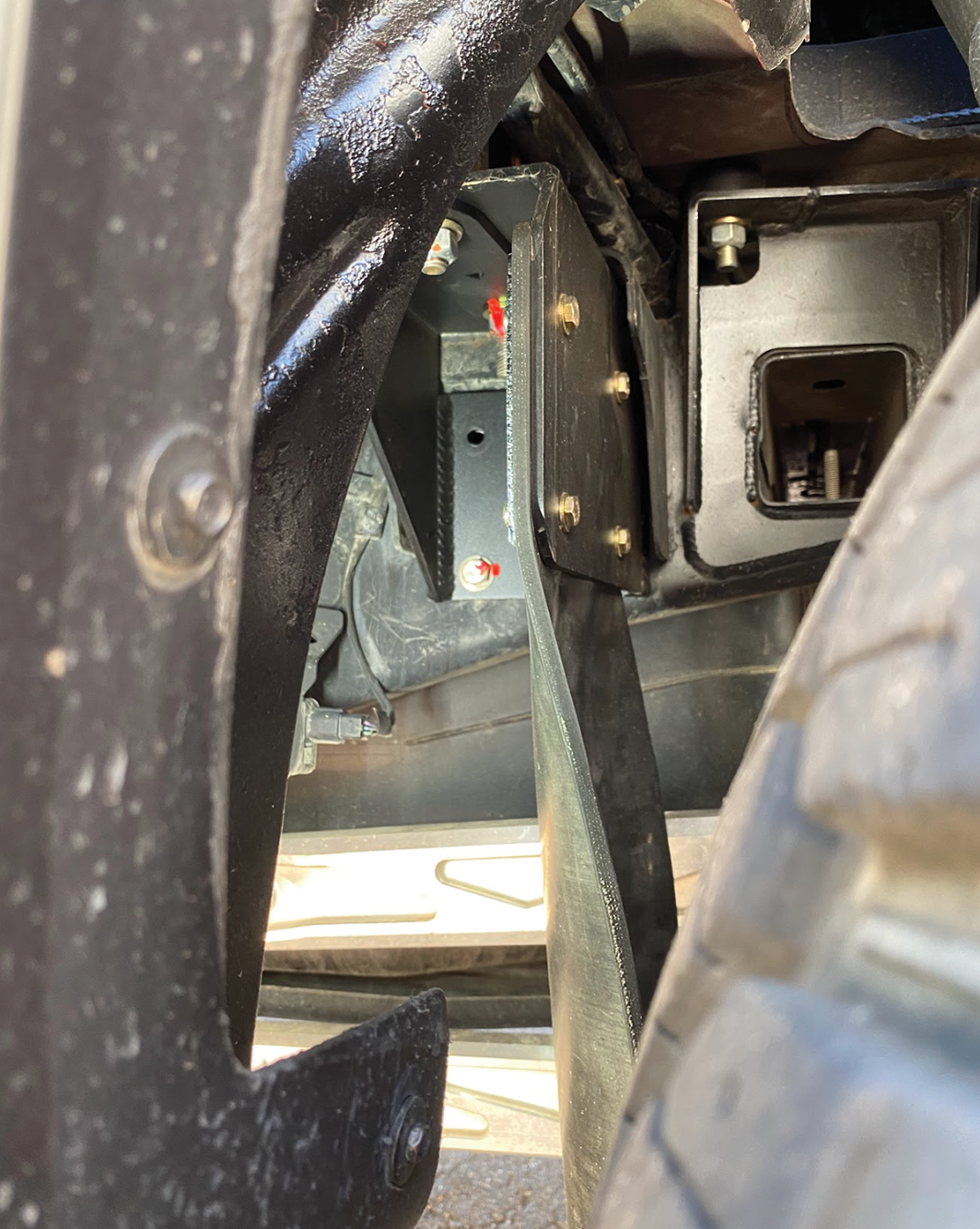 Rear shock guard mud flap frame mount kit for 2017-2024 Gen 2 and Gen 3 Raptor, showcasing installation details.