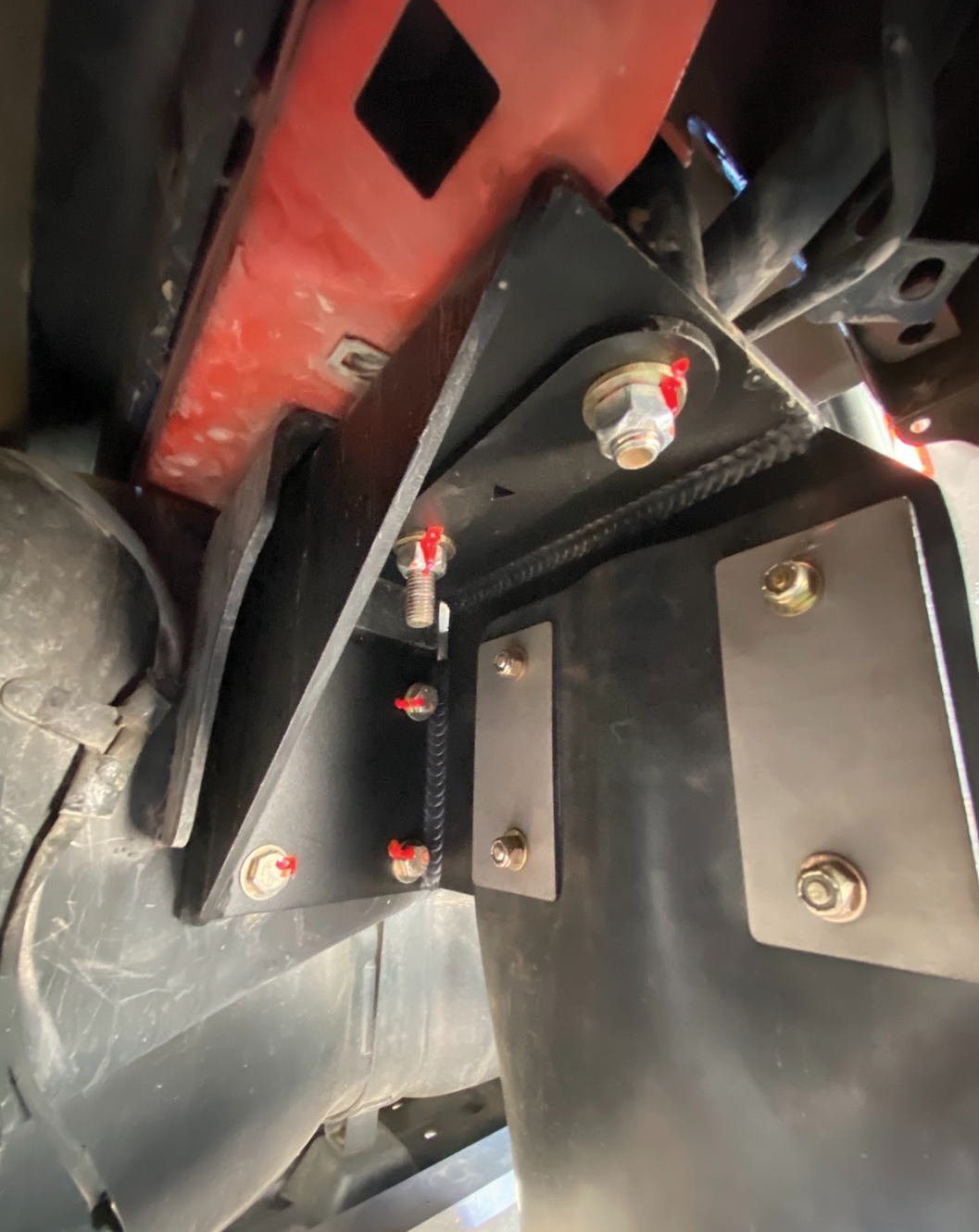 Rear shock guard mud flap frame mount kit for 2017-2024 Gen 2 and Gen 3 Raptor, showcasing durable metal construction and hardware.