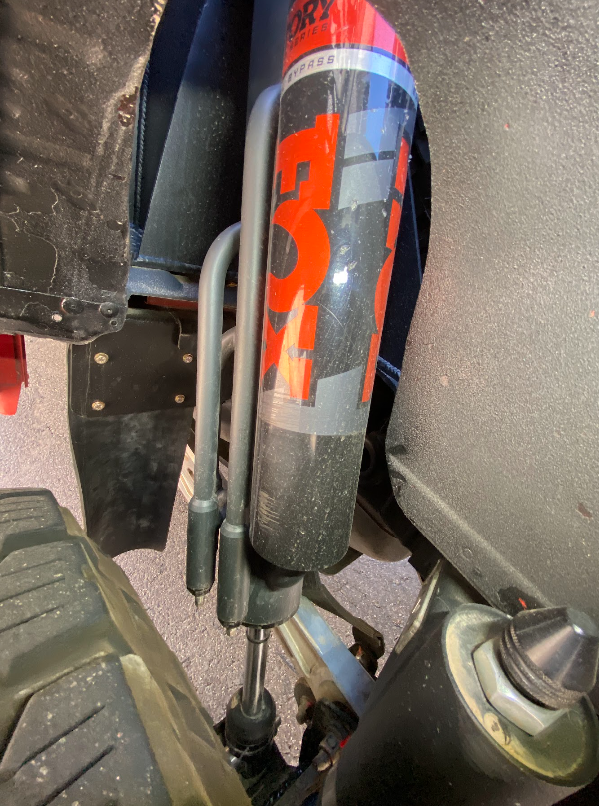 Rear shock guard mud flap frame mount kit for 2017-2024 Gen 2 & Gen 3 Raptor, showcasing shock absorber installation.