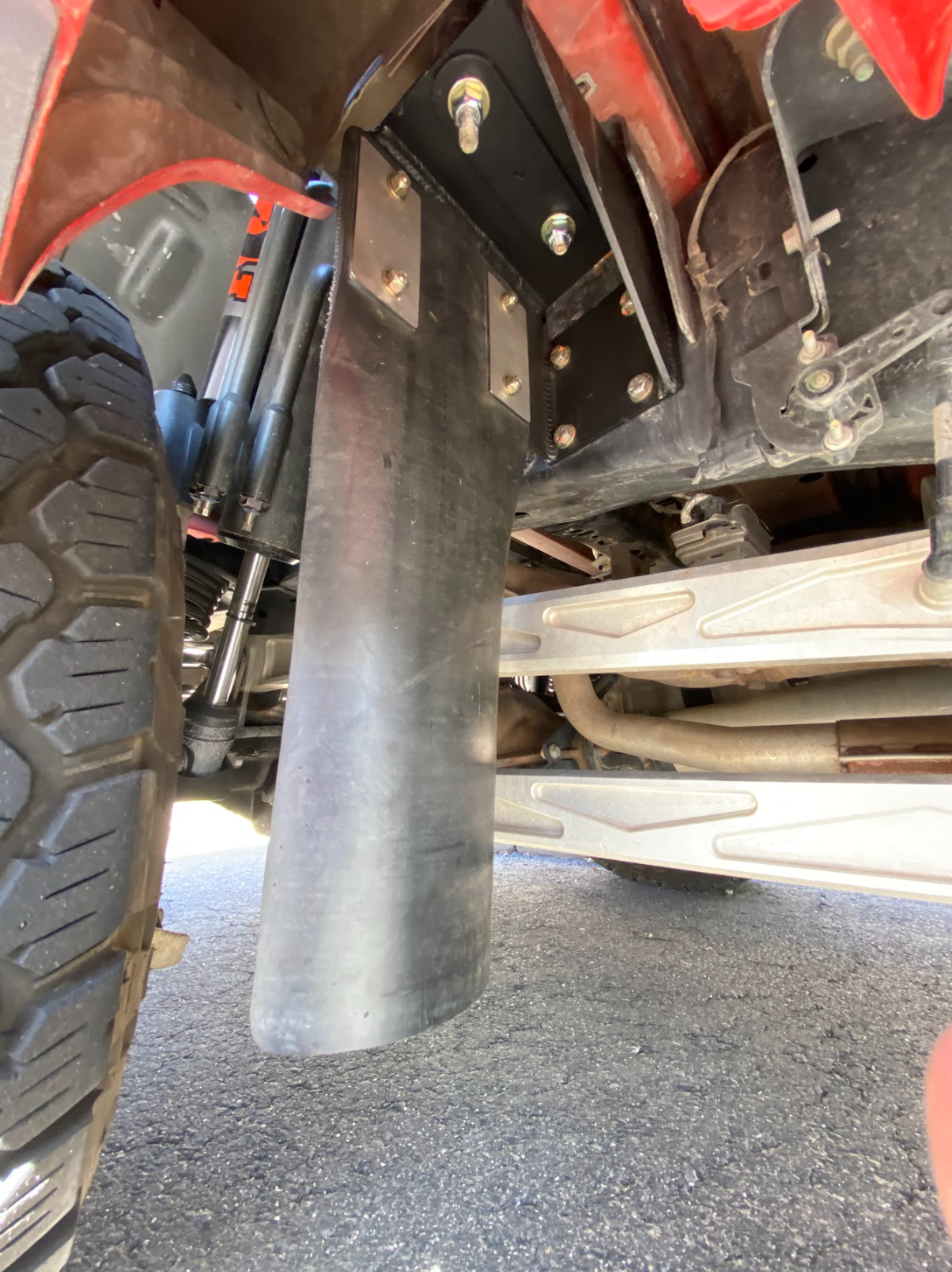 Rear shock guard mud flap frame mount kit for 2017-2024 Gen 2 and Gen 3 Raptor, showcasing installation under the vehicle.