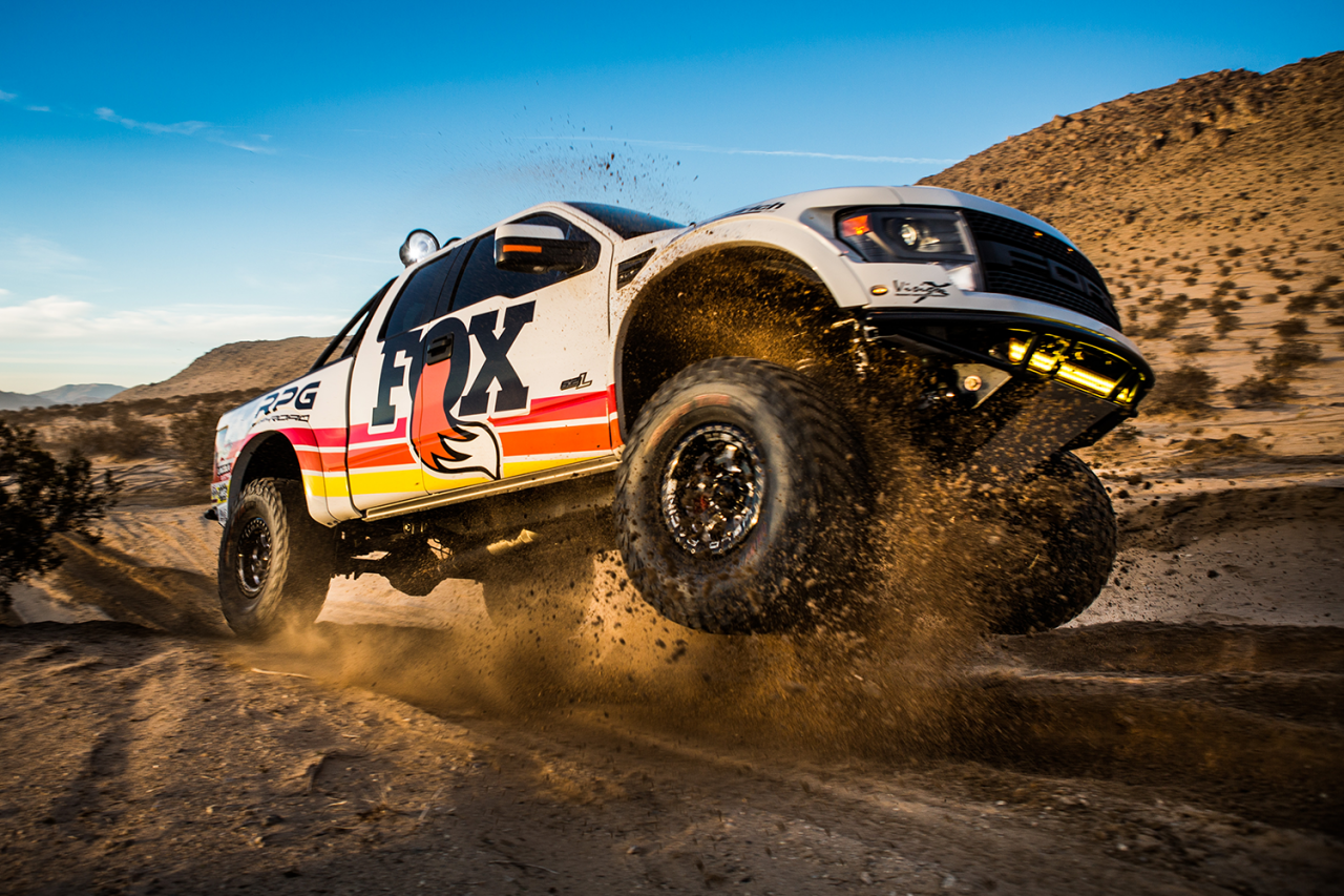 2010-14 Ford Raptor SVT equipped with FOX Factory Series shocks, airborne over desert terrain, showcasing off-road capability.