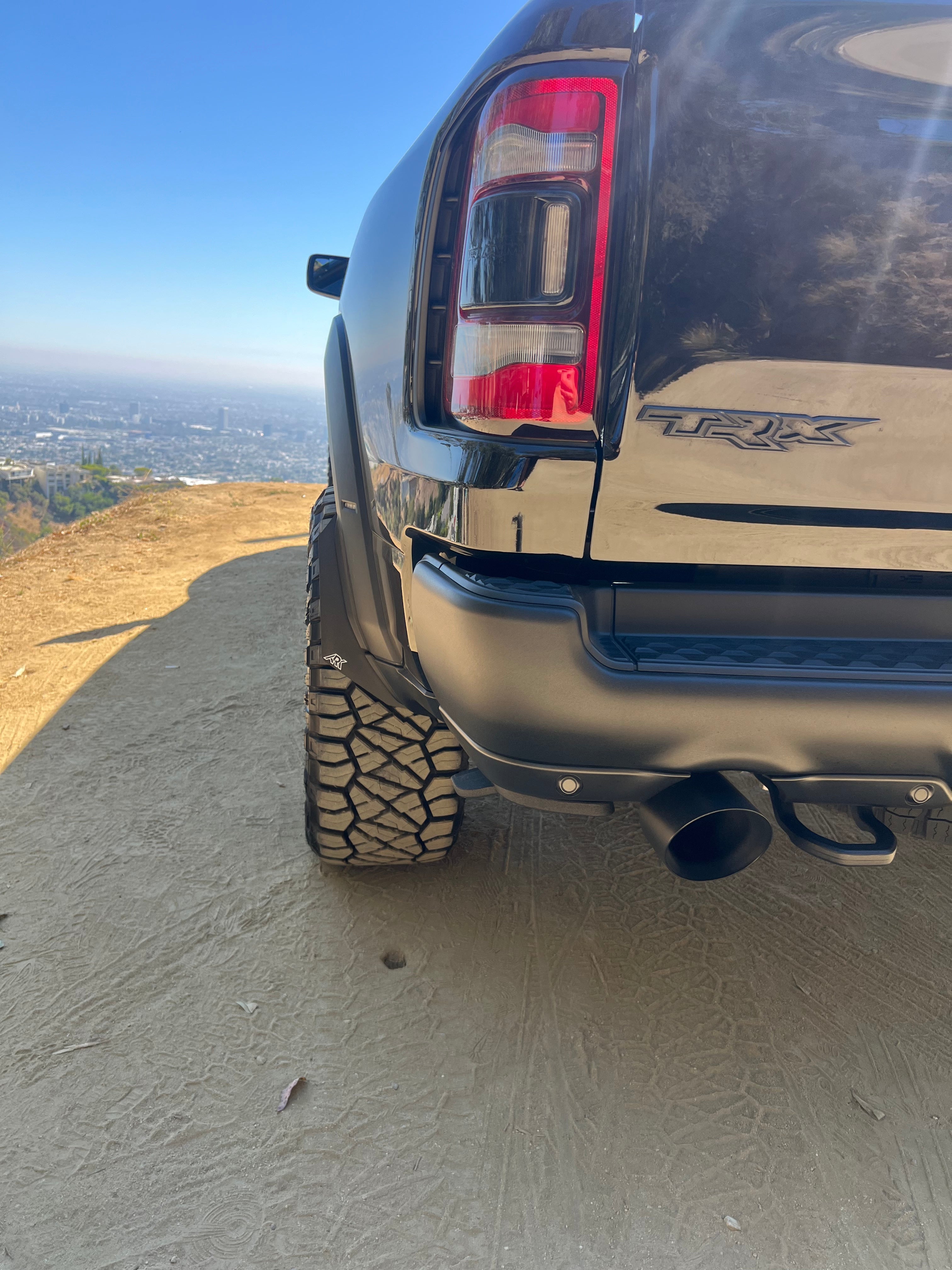 2025+ Dodge RAM RHO Micro Flares installed on a black truck, showcasing enhanced wheel coverage and rugged design.