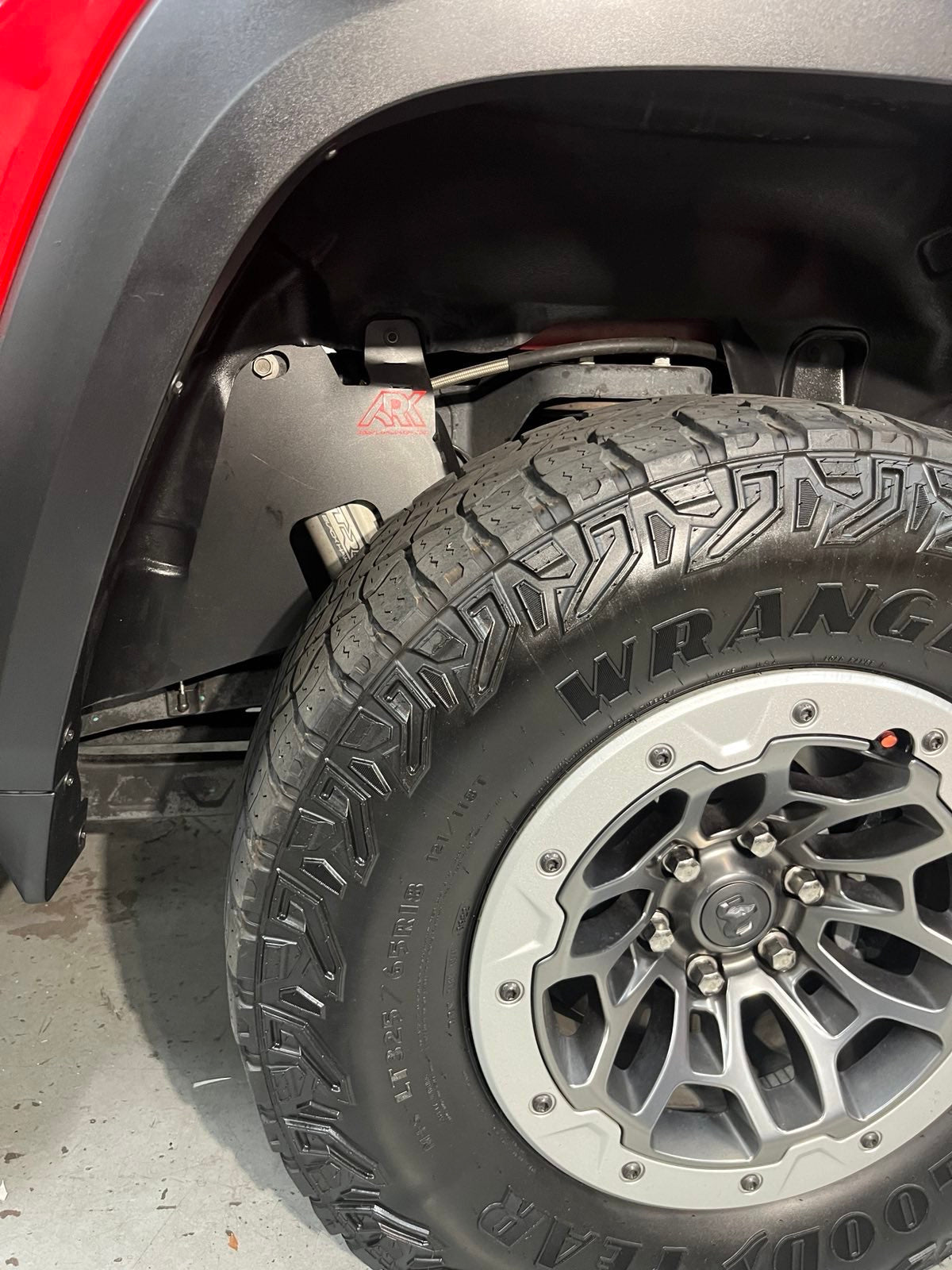 2025+ Dodge RAM RHO strut protection panel installed near tire, showcasing rugged design and offroad capability.