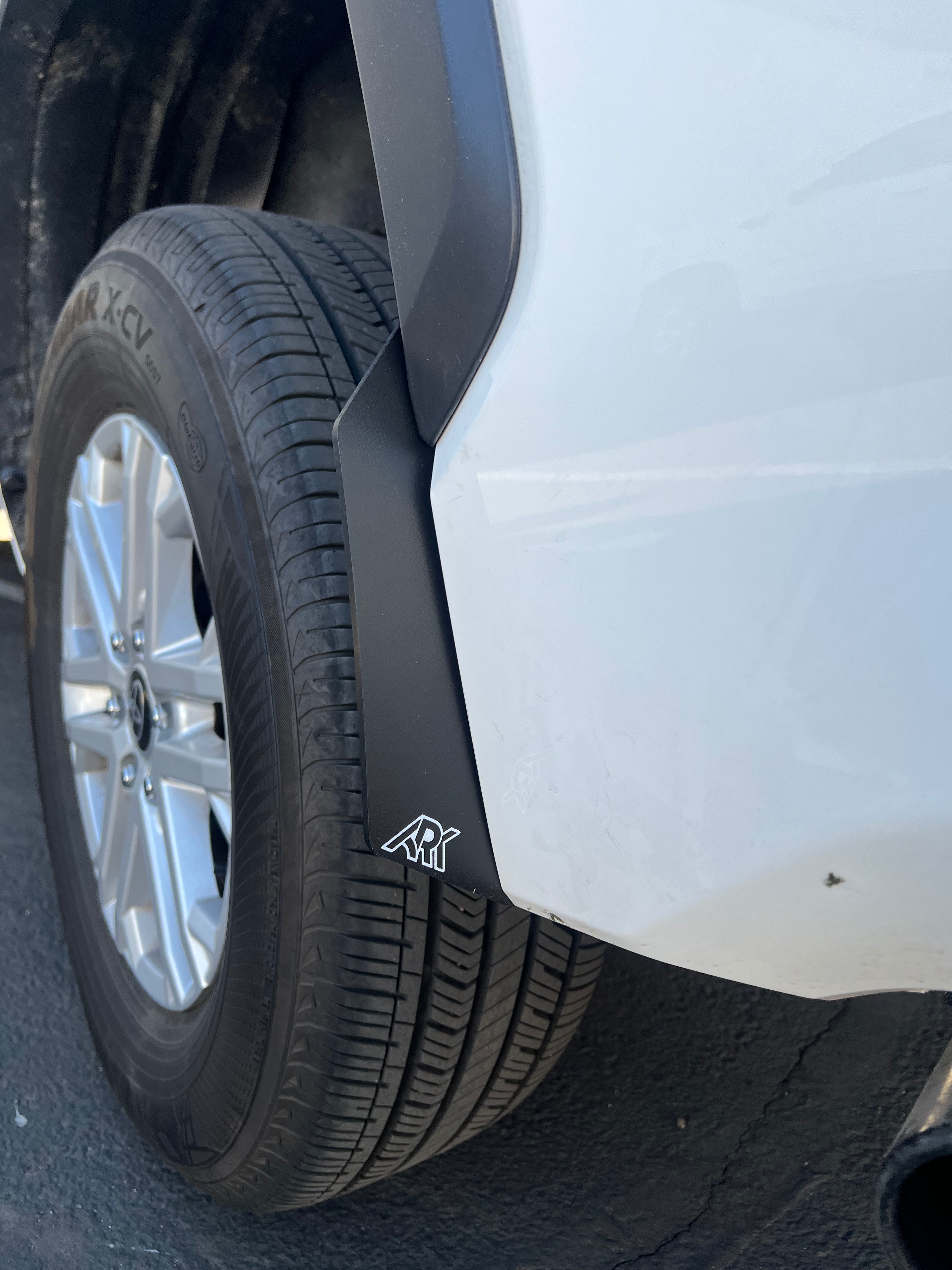 2022+ Toyota Tundra TriXpoly Micro Flares enhancing tire coverage and style, mounted on a white truck with alloy wheels.