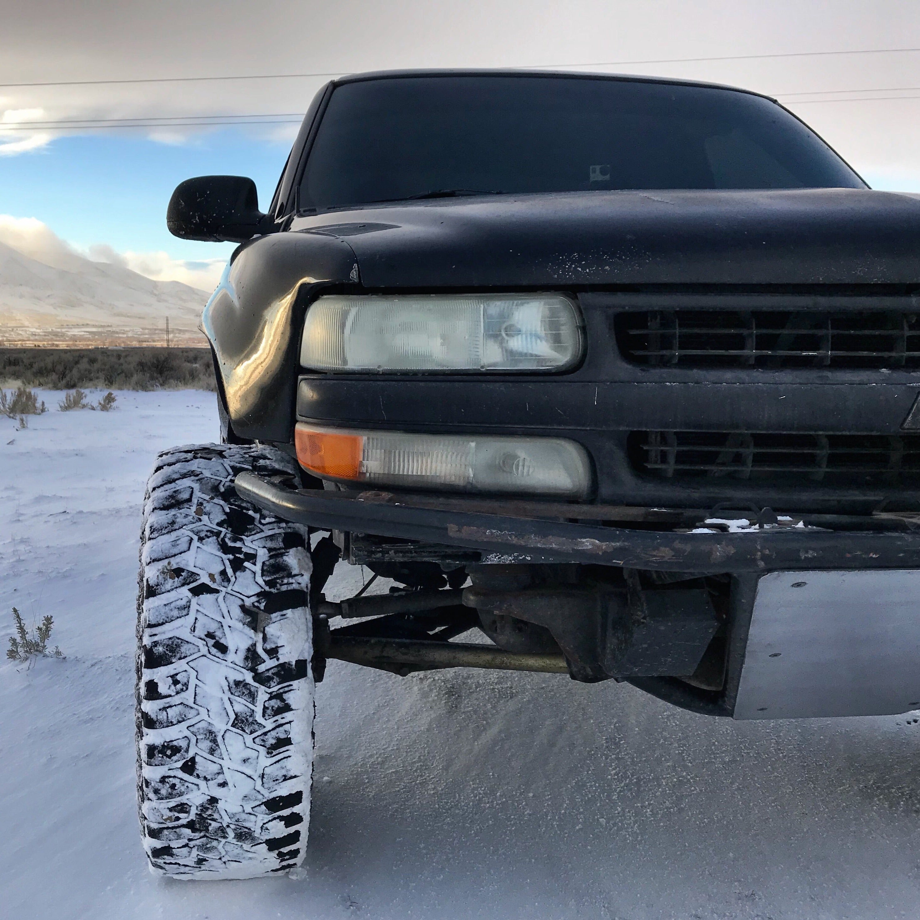 1999-2002 Chevrolet Silverado fenders on a lifted truck in a snowy landscape, showcasing rugged off-road capability.