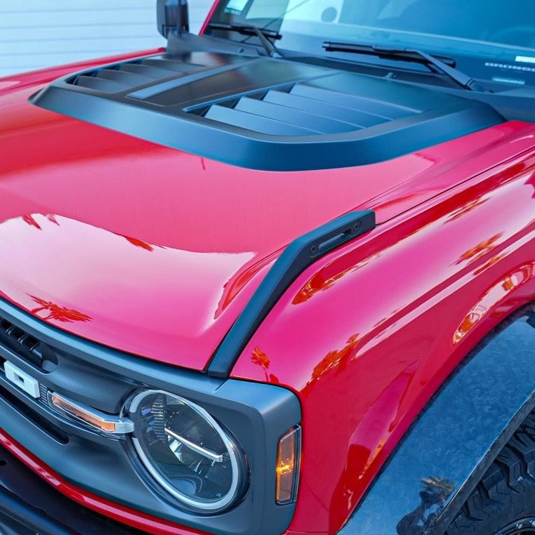 2021-2025 Ford Bronco heat extractor hood in red, featuring a sleek design and functional vents for improved airflow.