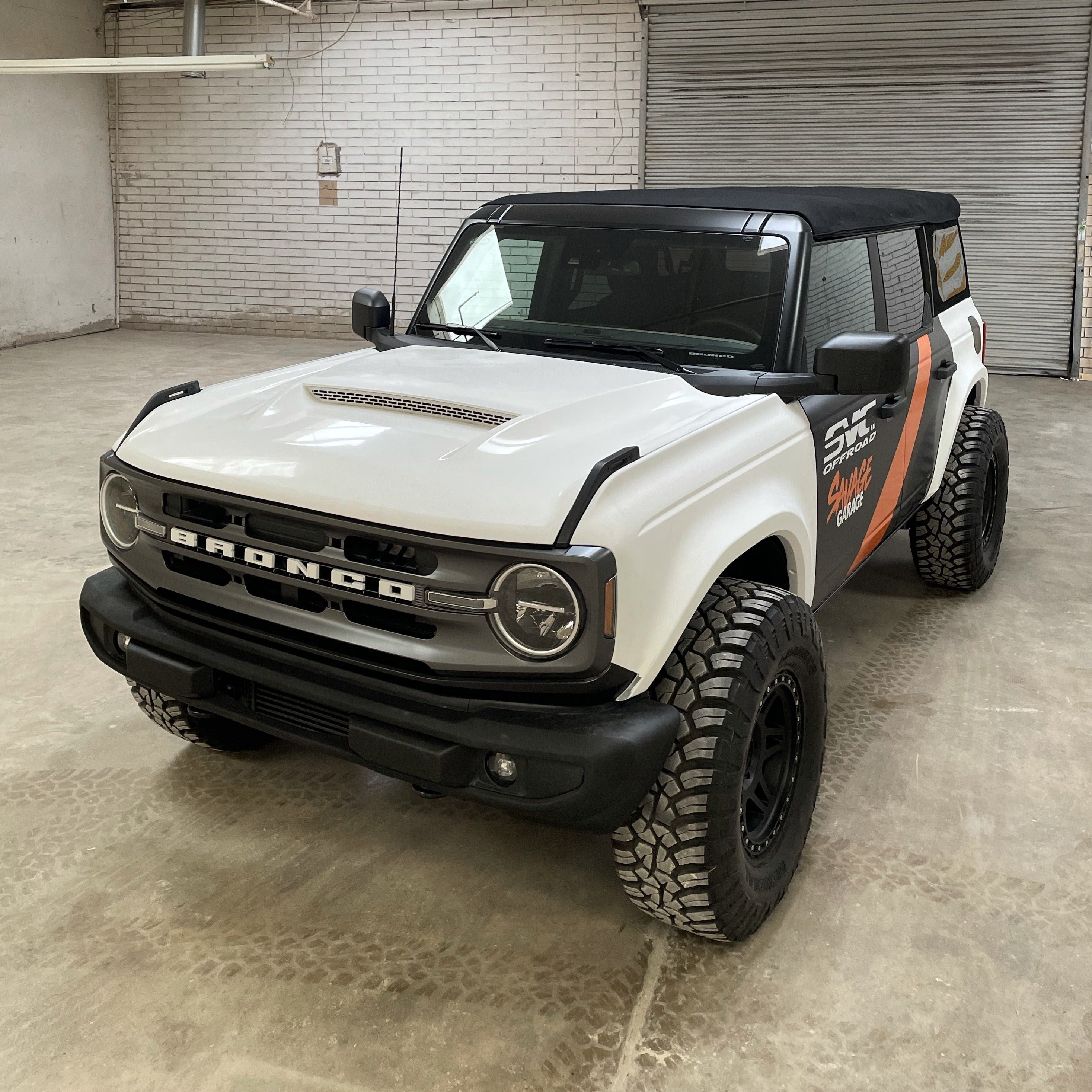 2021-2025 Ford Bronco fenders displayed on a modified white Bronco with off-road tires and a black soft top.