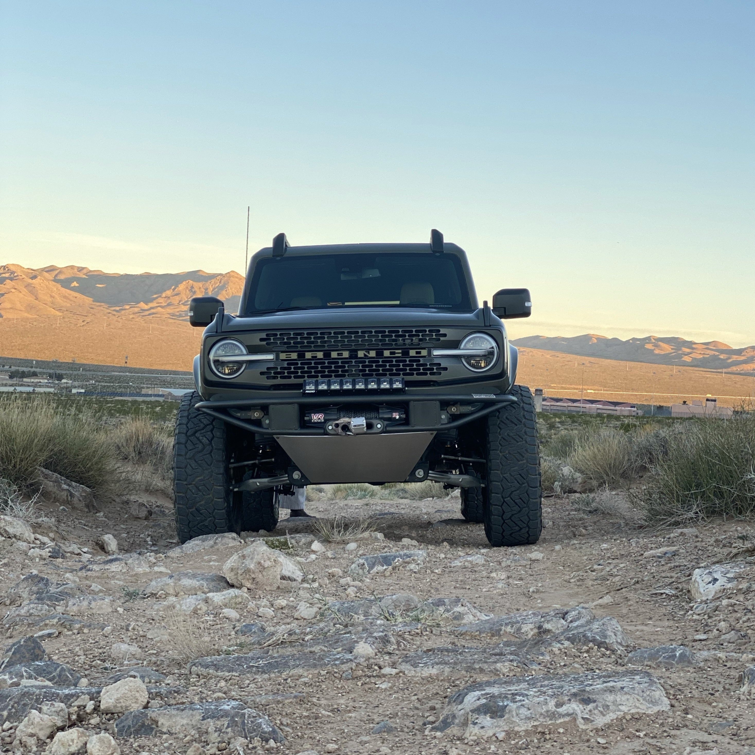 2021-2025 Ford Bronco fenders on a rugged offroad vehicle in a desert landscape, showcasing durability and style.