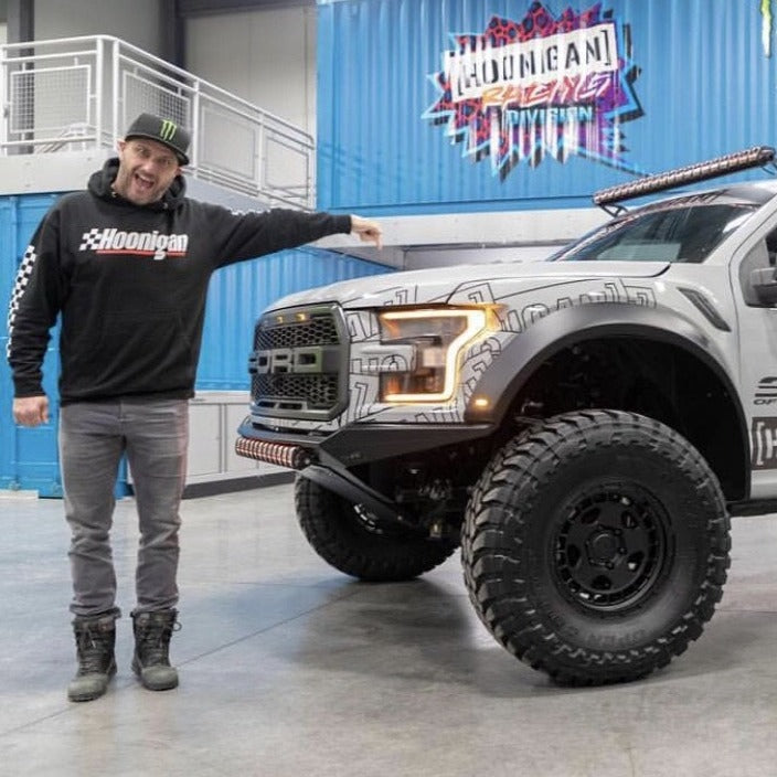 2017-2020 Ford Raptor fenders showcased on a modified truck in a showroom setting, highlighting offroad capabilities.
