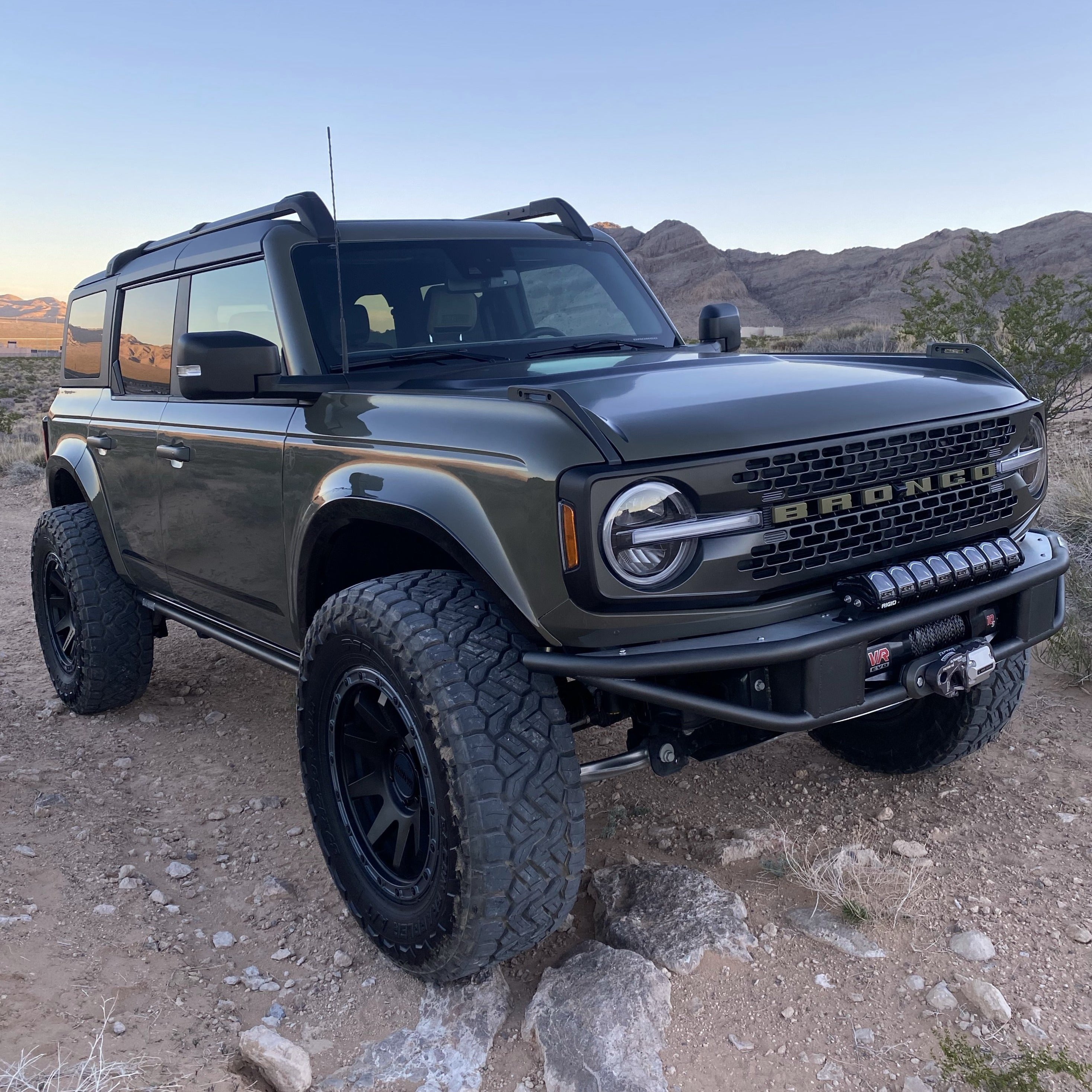 2021-2025 Ford Bronco with aftermarket fenders, showcasing off-road capabilities in a desert landscape.