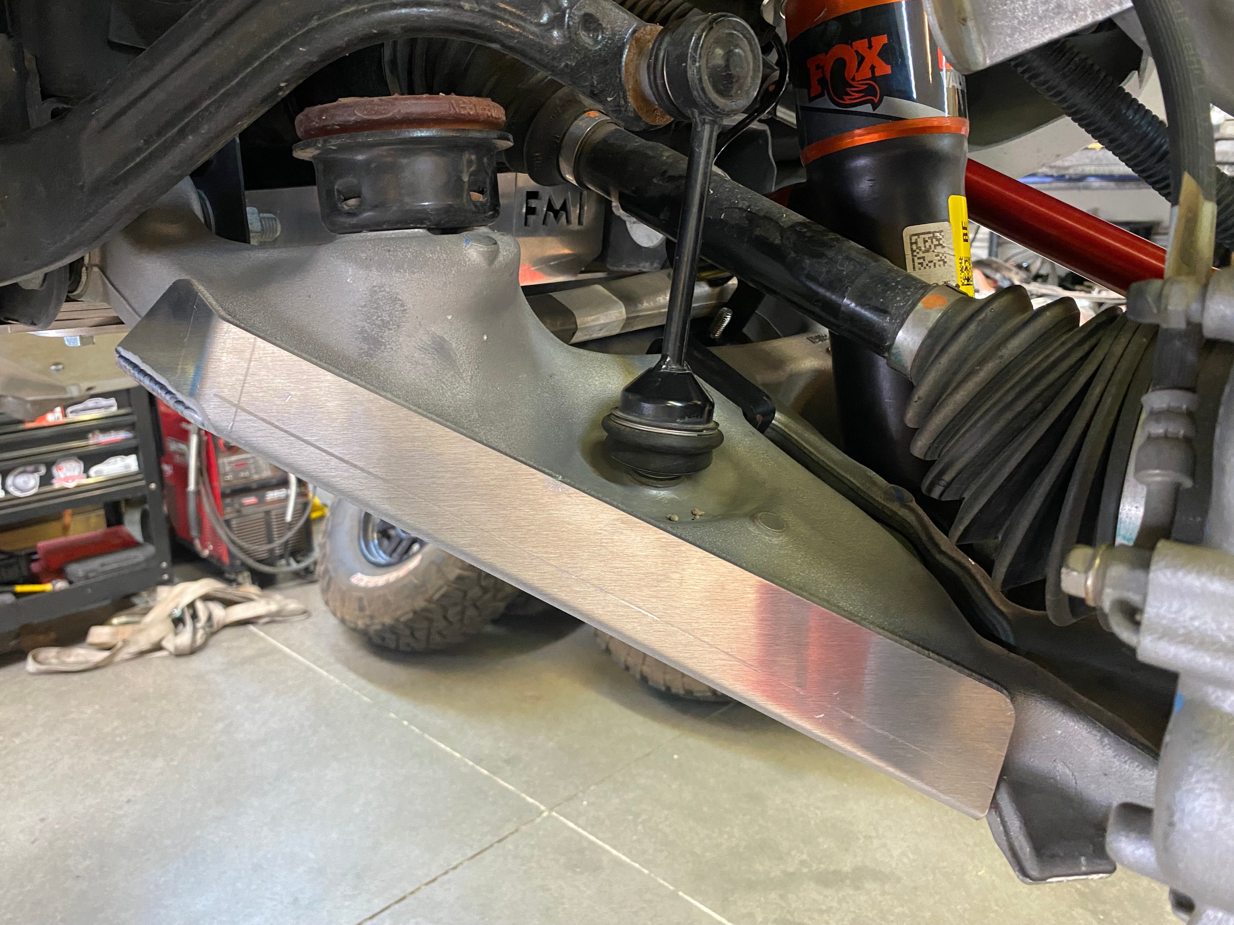 Bronco Raptor 2022 lower control arm skid plate kit installed on stock arm, showcasing durable protection for offroad use.