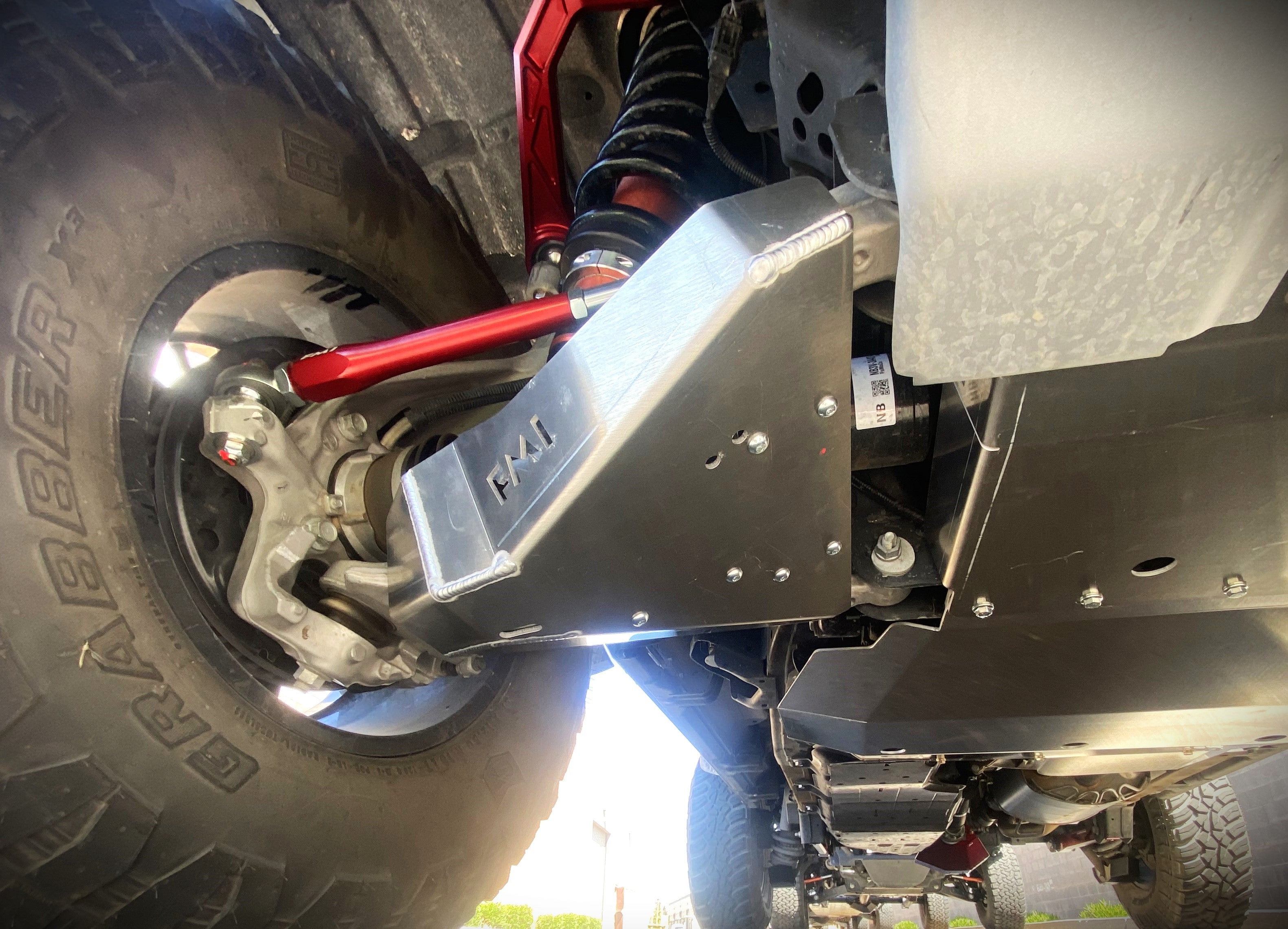 Bronco Raptor 2022 lower control arm skid plate kit installed on a vehicle, showcasing durable protection and design.