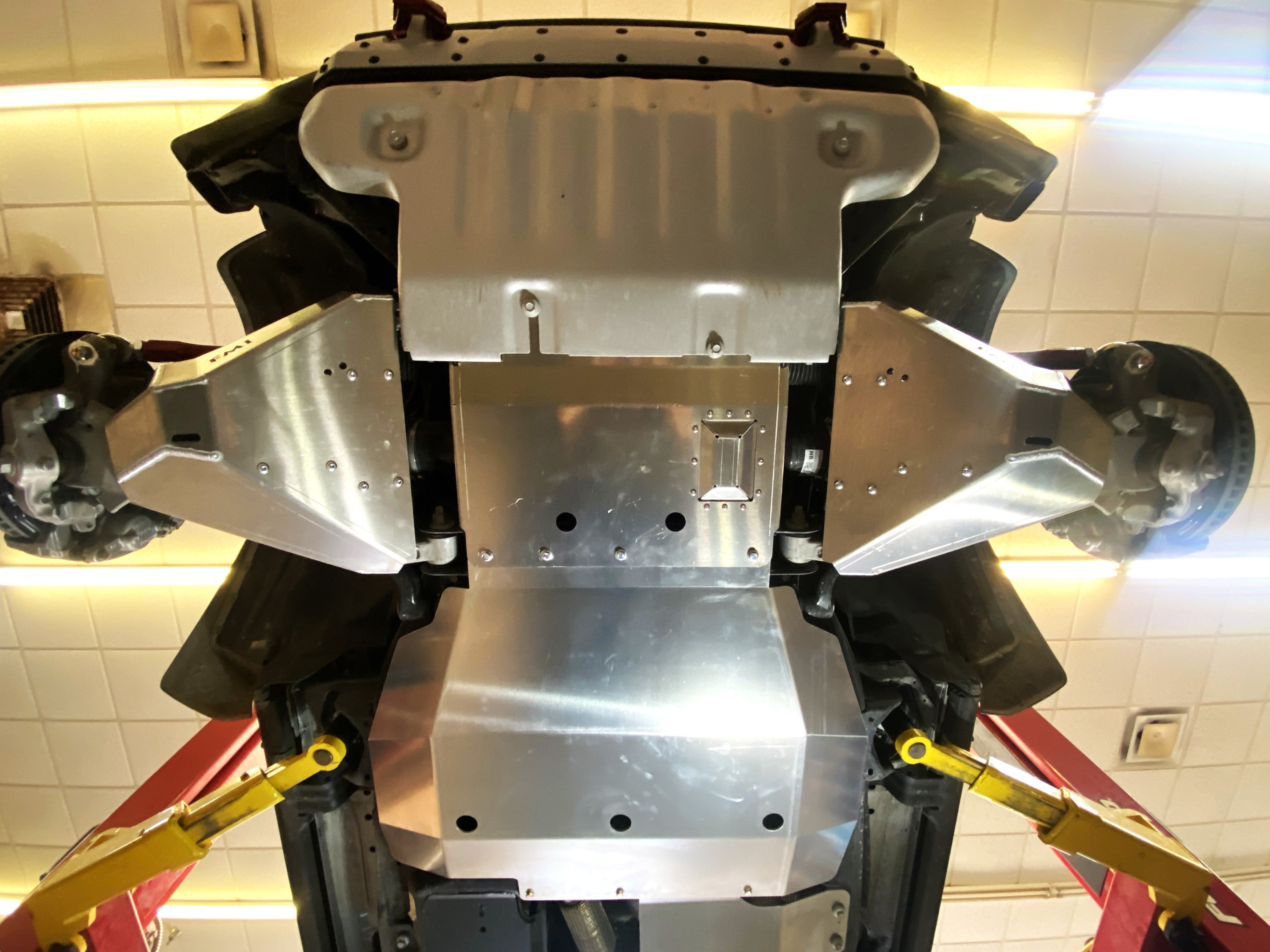 Bronco Raptor 2022 lower control arm skid plate kit installed, showcasing durable aluminum protection beneath the vehicle.
