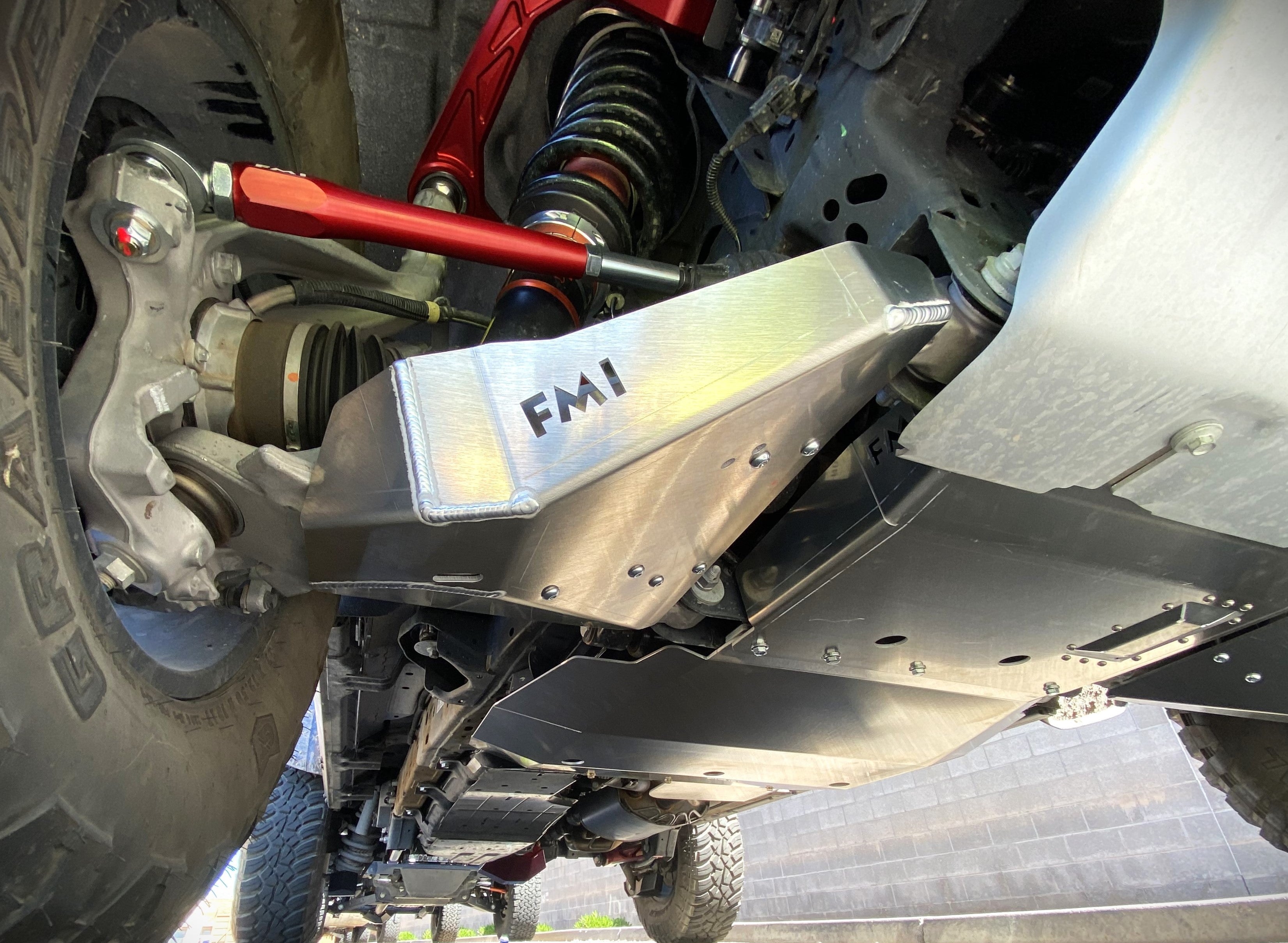 Bronco Raptor 2022 lower control arm skid plate kit installed on stock arm, showcasing durable aluminum protection.