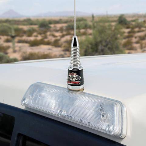 Brake light antenna mount installed on a vehicle roof, featuring a sleek design and clear desert background.